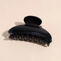 Close-up of a glossy black acrylic hair claw clip with a sleek curved semi-circular design - Black