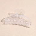 Macro detail of curved acrylic hair claw clip with golden metal spring and clear texture - Clear