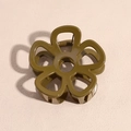 Overhead shot of an olive green flower hair claw clip with a detailed hollow design - Dark Yellow