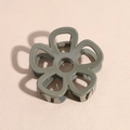 Close-up of olive green flower hair claw clip with a hollow five-petal resin design - Dark Gray