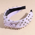 Detail of lavender twisted fabric headband featuring silver cone metal studs for a punk look - Purple