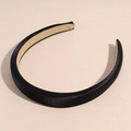 Close-up of black satin padded headband showing inner anti-slip lining and texture - Black