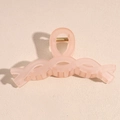 Close-up of a large matte pink shark hair claw clip with a hollow twisted design - Matte Coral