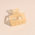 Macro detail of translucent yellow matte hair claw clip with hand made engraving - Orange