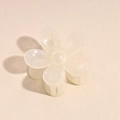 Detail of flower-shaped cream hair claw clip with semi-transparent resin and metal spring - Milky White