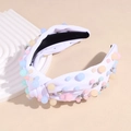 Detailed macro of white knotted headband with colorful macaron beads and sparkling rhinestones - White