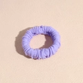 Detail of soft purple scrunchie with high elasticity fabric and pleated texture - Purple