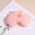 Close-up of pink jelly acrylic bow hair claw clip with semi-transparent resin texture - Pink