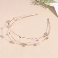 Detail of double-layer golden headband with pink cherry blossoms and small rhinestones - White