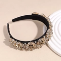 Close-up of amber crystals and diamonds on wide baroque headband with black fabric base - Champagne