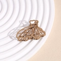 Detail of matte hollow butterfly hair claw clip in coffee brown on white display tray - Tortoise Shell Brown