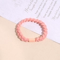 Close-up of pink braided hair tie with elastic weave and matching resin buckle - Peach