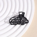 Detail of matte black hollow butterfly hair claw clip with metallic spring on a display tray - Butterfly Black