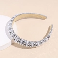 Close-up of Baroque headband with sparkling rhinestones and white pearls on velvet - Silver