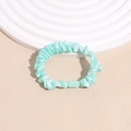 Detail of mint green pleated silk scrunchie with modern square plastic connector link - Green