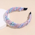 Close-up detail of pleated floral headband with purple fabric on a stone base - Printed Purple