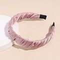 Detail of pink pleated satin headband featuring elegant ruched texture and nonslip ends - Pink
