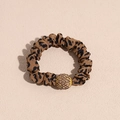 Detailed view of leopard print scrunchie with sparkling gold rhinestone ball charm - Leopard Rhinestone Style