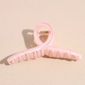 Close-up of a 13cm candy pink translucent hair claw clip with a golden metal spring - Large / Pink