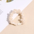 Detail of a creamy beige organza scrunchie featuring elegant pleated fabric texture - Beige