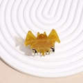 Detail of glittery gold bat hair claw clip with silver metal teeth for Halloween styling - Small Bat Yellow