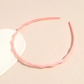 Close-up of pink wavy headband showing non-slip inner teeth and matte texture - Pink
