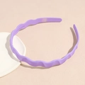 Detail view of purple wavy headband with anti-slip inner teeth and matte resin finish - Purple