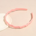 Close-up of pink wavy headband featuring non-slip inner teeth and matte finish - Light Pink