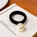 Elegant black elastic hair tie with a large glossy white pearl on a vintage book - Simple Single Pearl Style