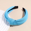Detail view of sky blue knotted fabric headband showing textured knit material - Teal