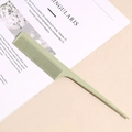 Macro detail of a light green wheat straw tail comb for precise hair styling and parting - Green