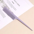 Detail shot of lavender purple pointed tail comb with fine teeth on a beige background - Purple