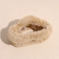 Detail of plush faux fur hair claw clip in light beige with golden metal spring component - Khaki