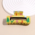 Detail of Christmas hair claw clip with Santa Baby print and festive holiday patterns - Yellow