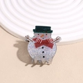 Close-up of cute snowman hair claw clip with glitter finish and festive scarf detail - Snowman