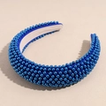 Detailed view of deep blue padded headband with dense faux pearl embellishments - Blue