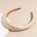 Close-up of padded beige leather headband with non-slip lining on a minimalist background - Beige