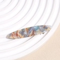 Detail of leopard print hair clip showing gold France Handmade text on marble texture - Blue Beige