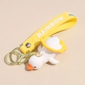 Close-up of white duck keychain with sunflower hat and yellow rainbow silicone strap - Rotating White Goose