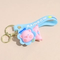Detail of pink cartoon pig keychain with blue RAINBOW strap and Sunny charm pendant - Rotating Pig