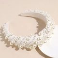 Detail view of premium white faux pearls arranged on a stylish padded sponge headband - White