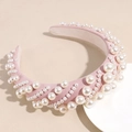 Close-up of pink fabric headband featuring high-quality pearls and elegant baroque details - Pink