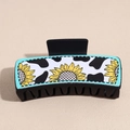 Detail of square hair claw clip featuring cow print and sunflower pattern on matte finish - Sunflower