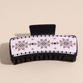 Detail view of large rectangular hair claw clip with bohemian geometric pattern on pink faux leather - Black Beige Diamond