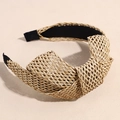 Detail of bohemian raffia headband featuring natural straw weaving and top knotted design - Khaki