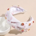 Close-up of white knotted headband with pink hearts, pearls and colorful rhinestones - Light Pink
