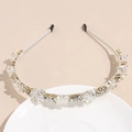 Detailed macro view of crystal rhinestones on a slim satin-wrapped metal headband - White
