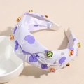 Detail of purple knotted headband featuring heart print, colorful crystals and white pearls - Purple