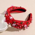 Detail view of red knotted headband featuring colorful rhinestones and pink pearls - Red