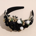 Detail of baroque headband featuring black silk roses, gold leaves, and white pearls - Black